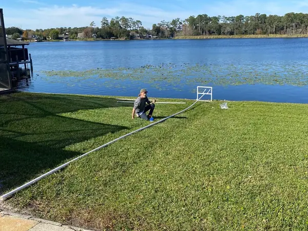 Lakefront lawn and pump line on a Central Florida lake