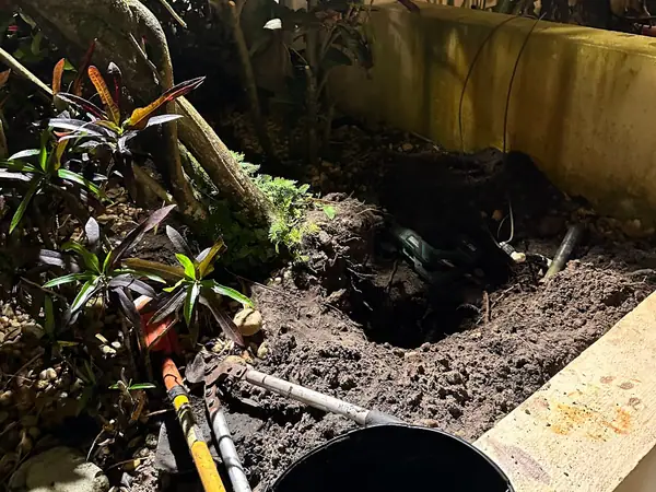 Valve box being set inside a raised block planter bed
