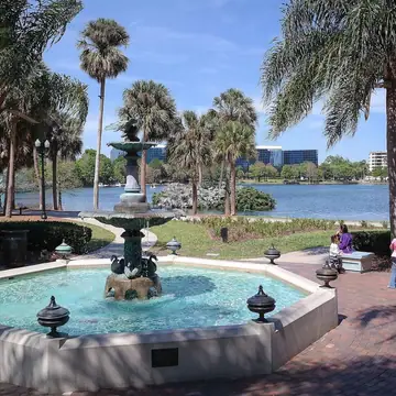 The Frank Sperry Fountain at Lake Eola Park, downtown Orlando, with the lake and skyline behind it